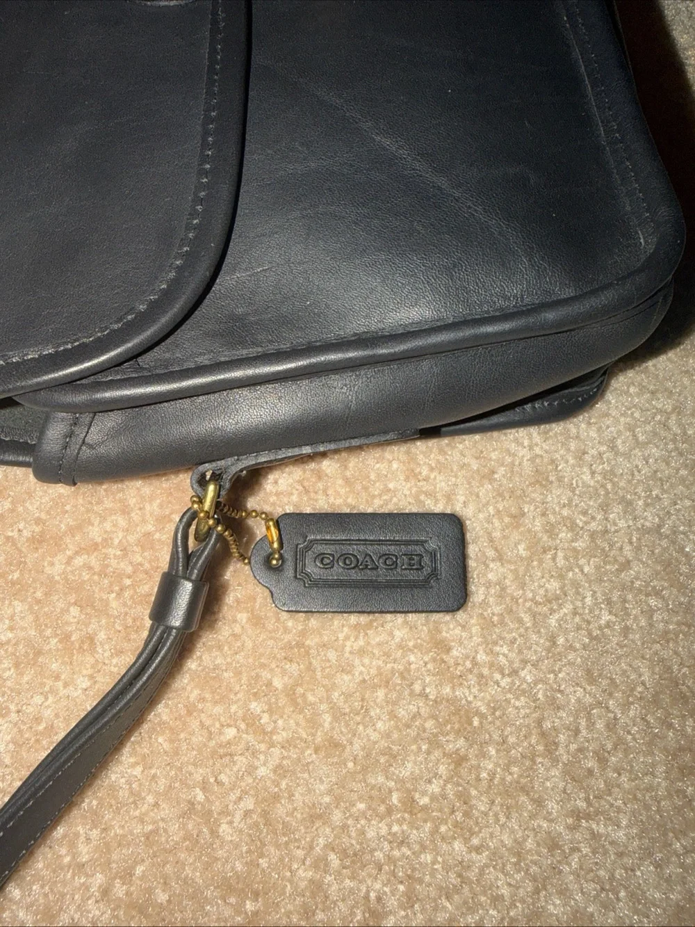 NWOT vintage black leather Coach wristlet features a classic a detachable strap